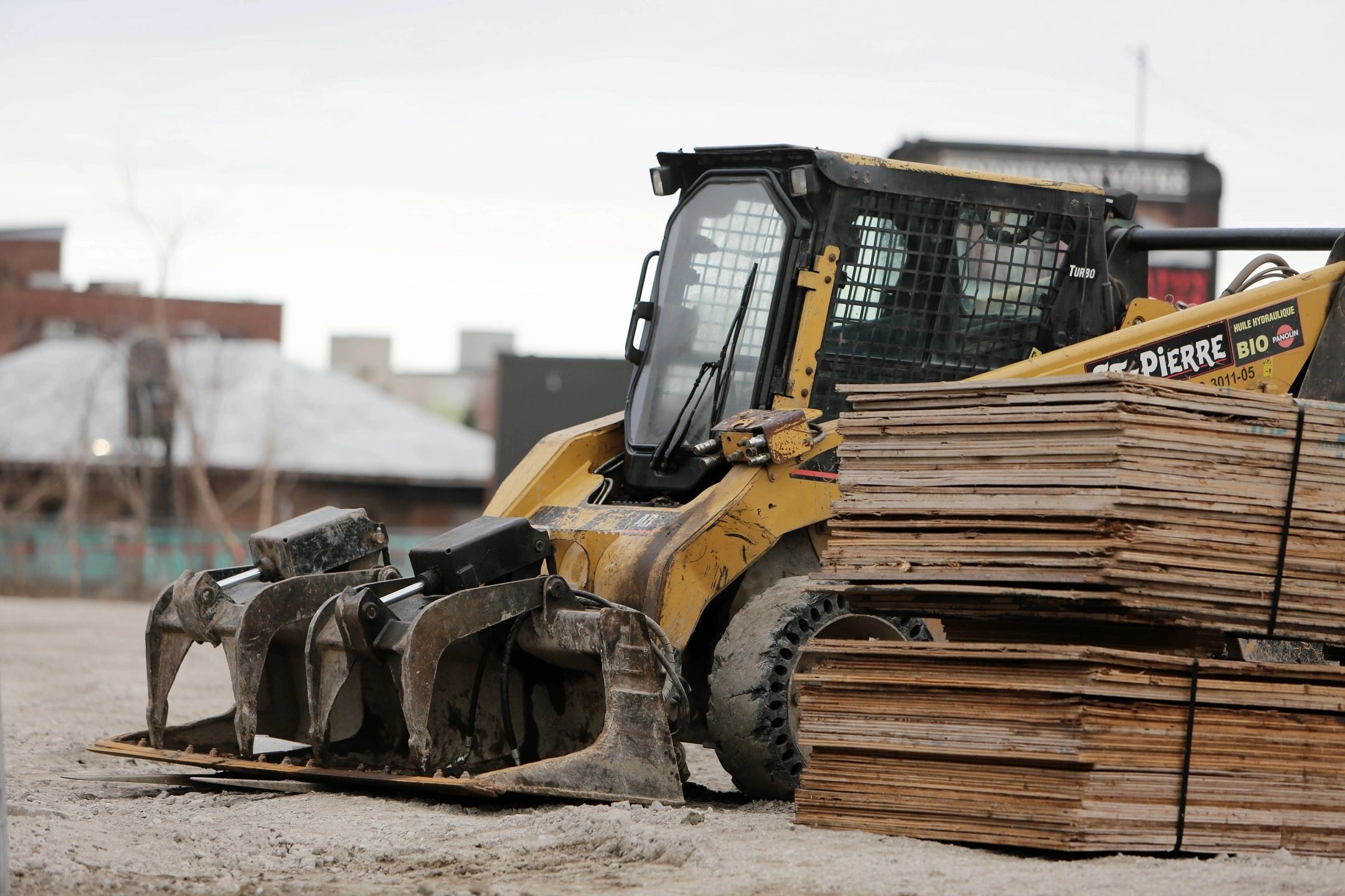 Skid steer loader with wooden pallets