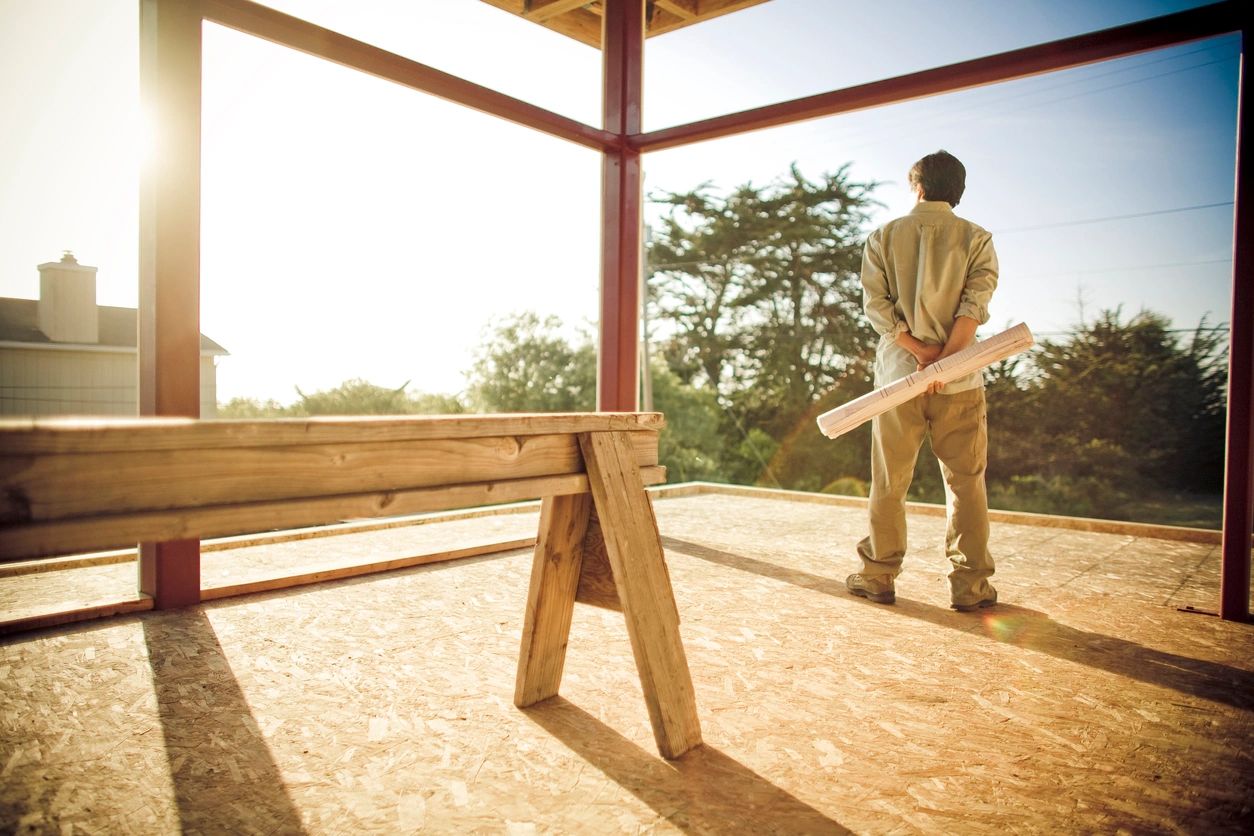 Construction worker holding wooden beam